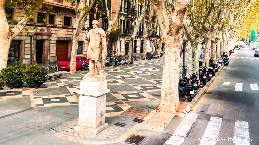 Statue along Passeig del Born in Palma de Mallorca, Spain — a tree-lined boulevard known for its historic charm and elegant architecture.