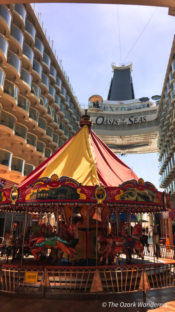 Carousel on the Boardwalk aboard Royal Caribbean’s Oasis of the Seas, framed by the ship’s balconies and open-air design.
